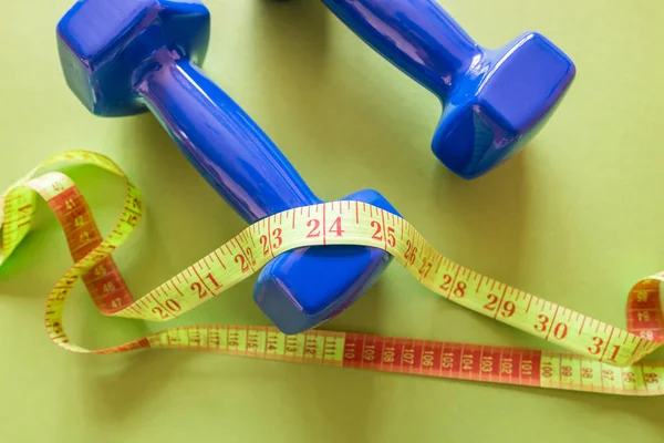 Fitness Concept Photo Tape Measure Dumbbells Isolated Green Background — ストック写真