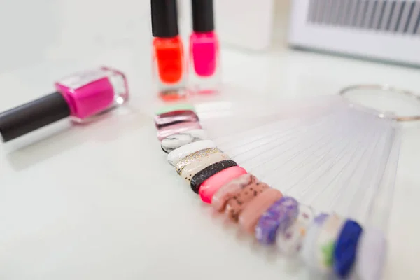 Various colorful nails, manicure palette. Nail polish samples. selective focus. palette with samples of nail polish. collection of samples of varnishes for manicure. well-groomed hands, healthy nails. Selective focus. nail design samples.