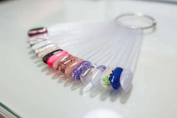 Various colorful nails, manicure palette. Nail polish samples. selective focus. palette with samples of nail polish. collection of samples of varnishes for manicure. well-groomed hands, healthy nails. Selective focus. nail design samples.
