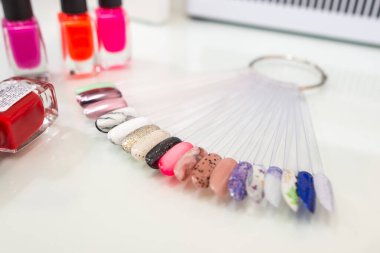 Various colorful nails, manicure palette. Nail polish samples. selective focus. palette with samples of nail polish. collection of samples of varnishes for manicure. well-groomed hands, healthy nails. Selective focus. nail design samples.
