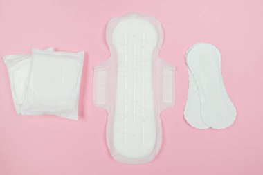 Top view photo of pads on pink background. The concept of women's periods.