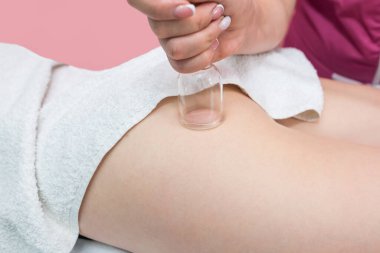 hardware cosmetology. Vacuum massage procedure in the medical beauty center. Close-up of young woman's anti-cellulite cupping therapy.