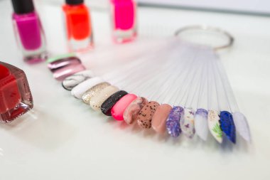 Various colorful nails, manicure palette. Nail polish samples. selective focus. palette with samples of nail polish. collection of samples of varnishes for manicure. well-groomed hands, healthy nails. Selective focus. nail design samples.