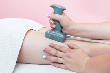 Close-up of a woman undergoing an anti-cellulite massage procedure in a beauty salon