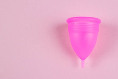 pink female menstrual cup on a pink background. Feminine hygiene. Menstruation. Place for text. copy space