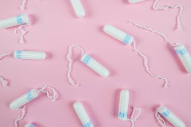 female tampons on a pink background. Hygienic white tampon for women. Cotton swab. Menstruation.