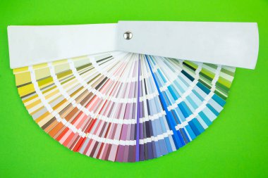 Renk rehberi yaklaş. Tasarım için çeşitli çiçekler. Yeşil arkaplanda renk paleti fanı. Grafik tasarımcısı renk paleti rehberinden renk seçer. Renk kumaşı kataloğu