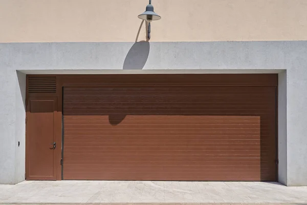 Wide rolling garage door with door — стоковое фото