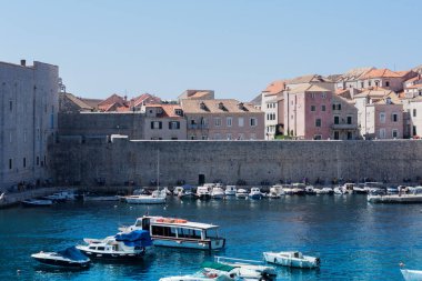 Hırvatistan 'ın Dubrovnik kenti, limana tarihi Dubrovnik kentinin arka planına sahip yelkenli ve zevk tekneleriyle bakıyor 