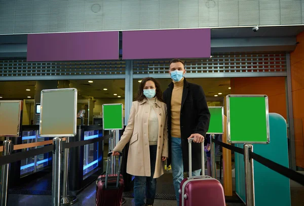 Young Couple Business Partners Protective Medical Masks Standing Suitcases Check — Stock fotografie