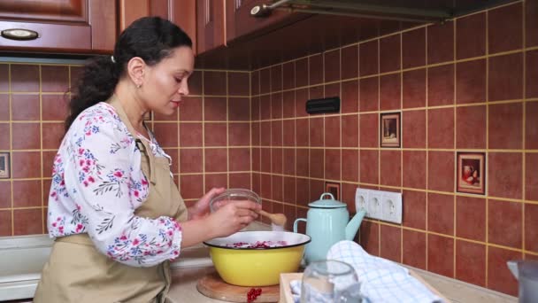 Charming Multiethnic Woman Housewife Apron Using Wooden Spoon Stirs Red — Stok video