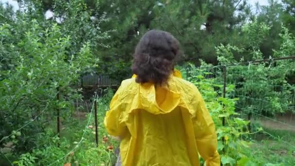 View Back Dark Haired Woman Agriculturist Wearing Yellow Raincoat Walking — Stock videók
