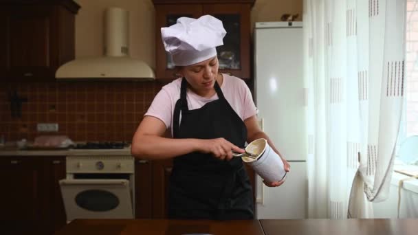 Multiethnic Woman Housewife White Chef Cap Black Kitchen Apron Extracting — стоковое видео