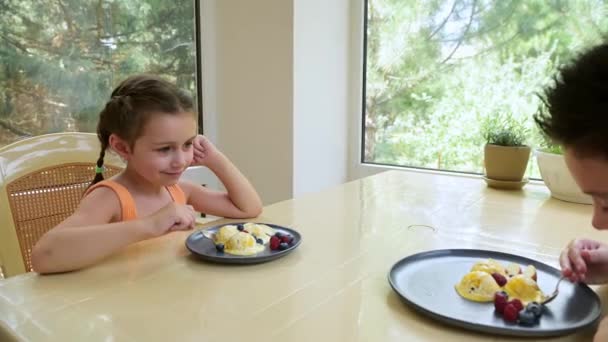 Adorable Little Girl Enjoying Delicious Snack Her Older Brother Eating — стоковое видео