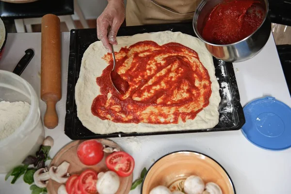 View Housewife Beige Chefs Apron Spreading Freshly Made Tomato Sauce — Fotografia de Stock