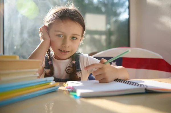 Cute Little Girl First Grader Studies Sitting Chair American Flag —  Fotos de Stock