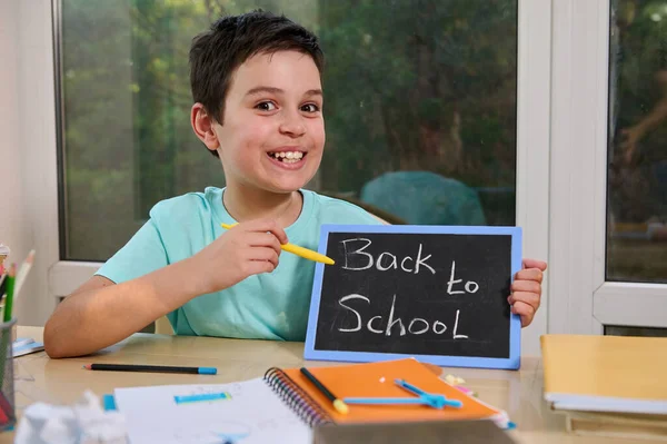 Cute Schoolboy Points Pencil Chalkboard Inscription Back School Sitting Table — Fotografia de Stock