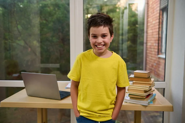 Portrait Handsome Caucasian Schoolboy Standing Table Laptop School Supplies Stacked — Foto de Stock