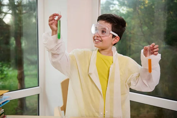 Smart Teenage Schoolboy Protective Goggles White Lab Coat Makes Scientific — Stock Fotó