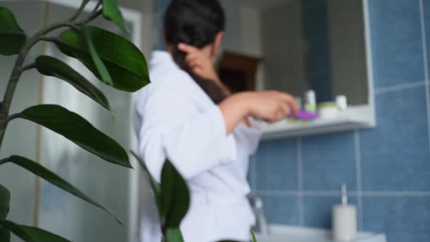 View Houseplant Curly Brunette Pretty Woman White Bathrobe Combing Hair — ストック動画