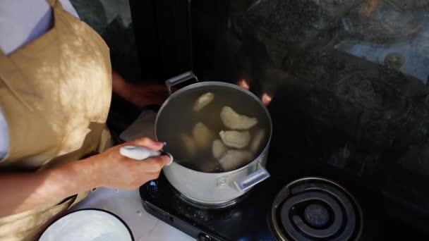 Top View Housewife Apron Using Kitchen Spoon Stirring Dumplings Cooking — стокове відео