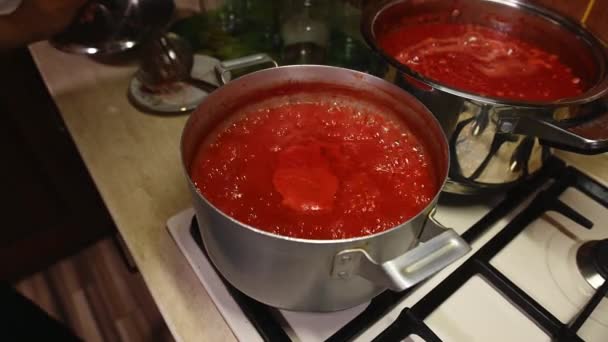家庭のキッチンで 伝統的な家族のレシピによると 熟した有機ジューシーなトマトから自家製パスタを準備し 沸騰トマトジュースを攪拌トップビュー 食料を缶詰にする ステップバイステップのレシピ — ストック動画