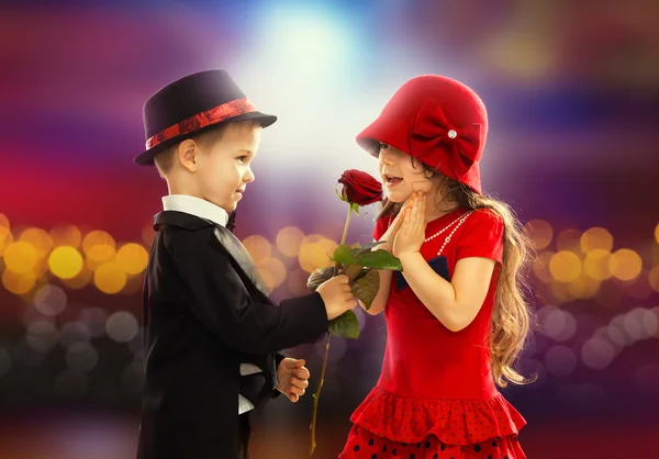 Lovely little boy giving a rose to girl — Stock Photo, Image
