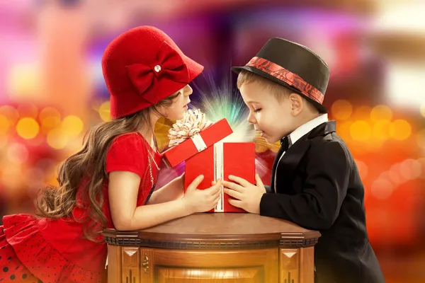 Happy children opening magic gift — Stock Photo, Image