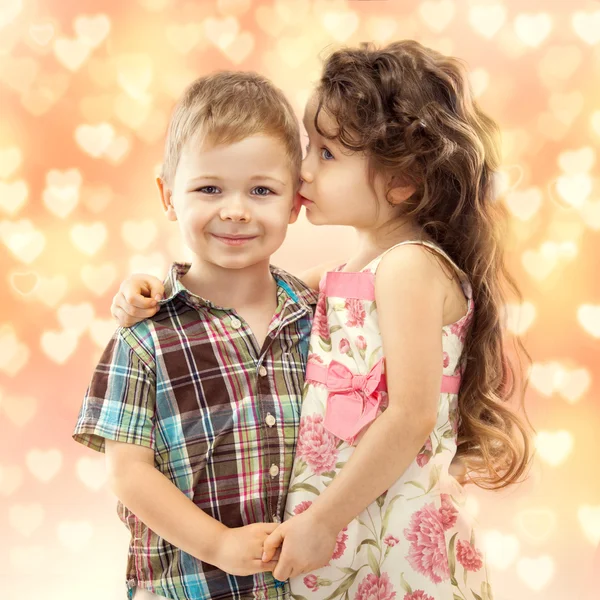 Little girl whispering something to boy — Stock Photo, Image