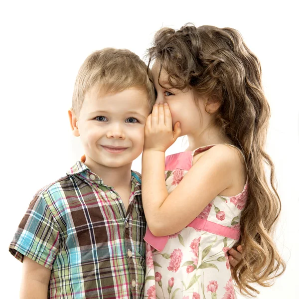 Little girl whispering something to boy — Stock Photo, Image