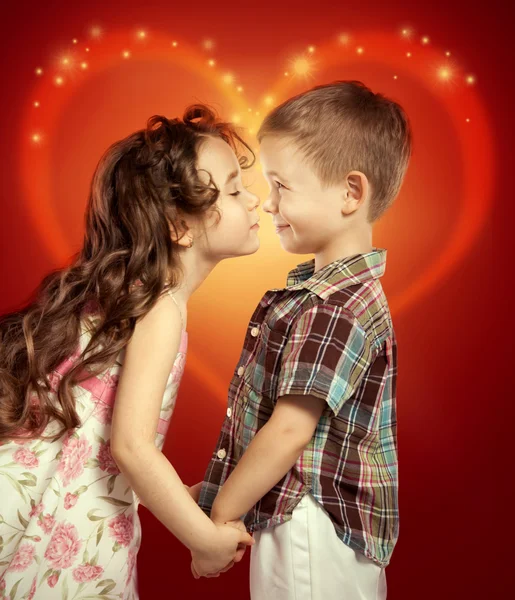 Little girl kissing boy Stock Photo