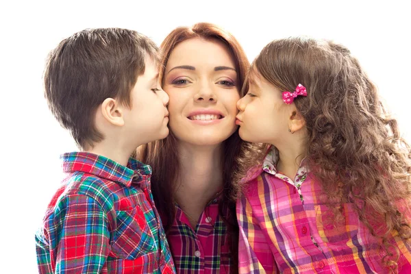 Happy mother kissed by her daughter and son — Stock Photo, Image