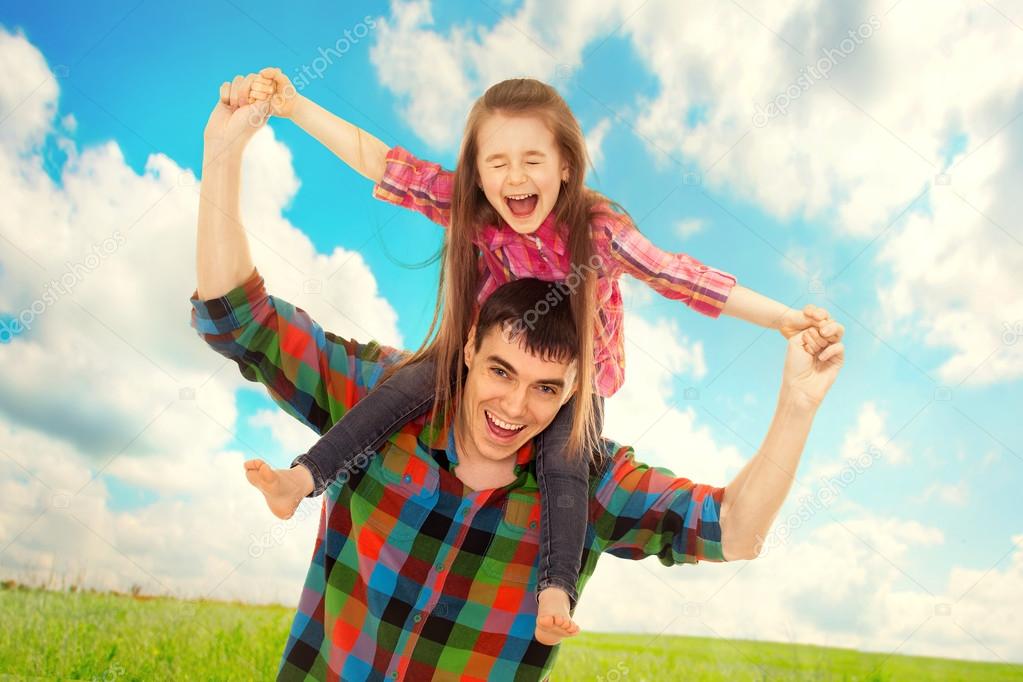 Father with daughter on shoulders