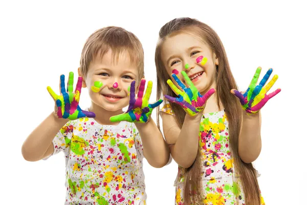 Menina e menino com as mãos pintadas em tinta colorida — Fotografia de Stock