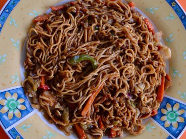 mi goreng and vegetables on a plate
