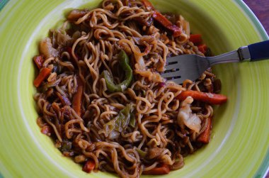 mi goreng and vegetables on a plate