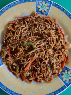 mi goreng and vegetables on a plate
