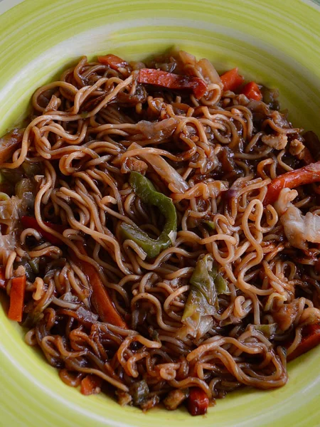 mi goreng and vegetables on a plate