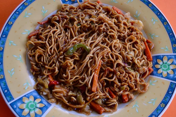 mi goreng and vegetables on a plate
