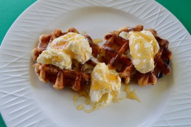 Belgian waffles with extra creamy ice cream and honey