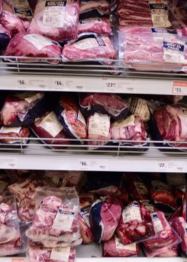 Packaged meat stacked on shelves in the supermarket