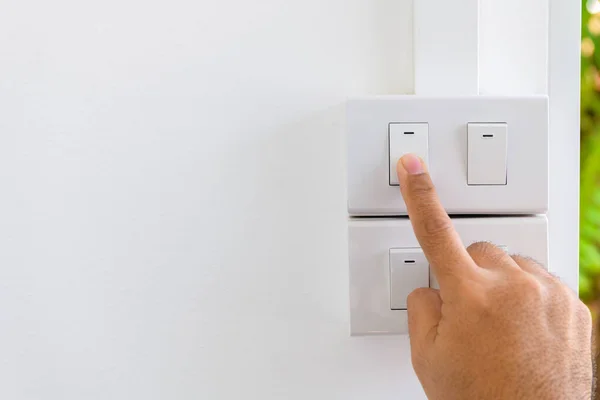 Press turn on/off electrical switch, save electricity and energy concept