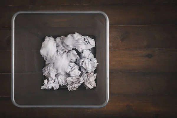 Motion of crumpled in rubbish bin. Waste paper in office garbage bin ...