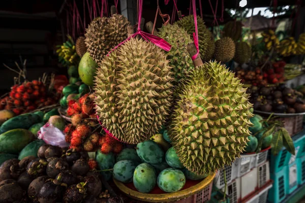 Fruit shop in Thailand. Fruit market in Indonesia Bali island. Street bazaar in Asia. Sale of fresh fruits and vegetables at the market in Thailand. A small grocery store on the street of Bali island