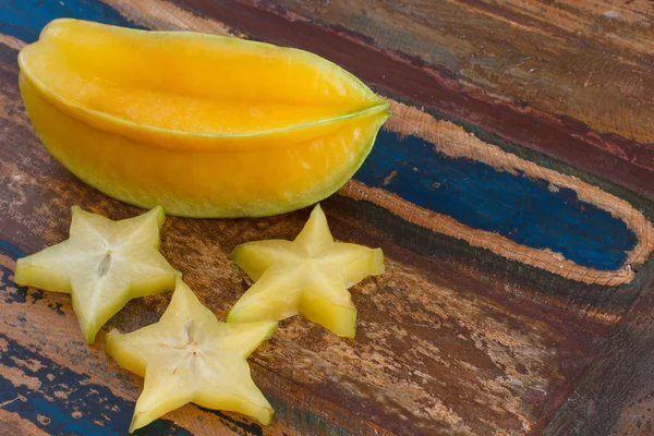 Carambola e fatias na mesa — Fotografia de Stock