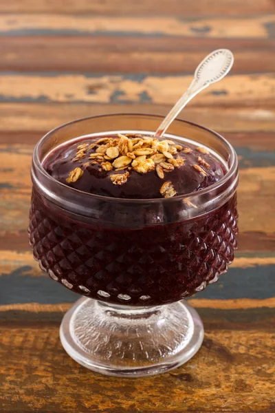 巴西莓与牛奶什锦早餐木制的桌子上的杯子里。垂直 — 图库照片