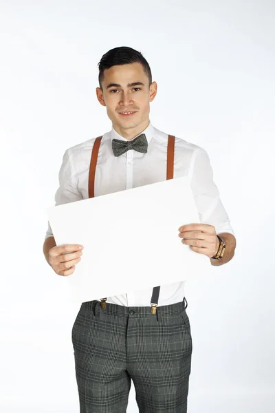 Young smiling man holding white card to write it on your — Stock Photo, Image