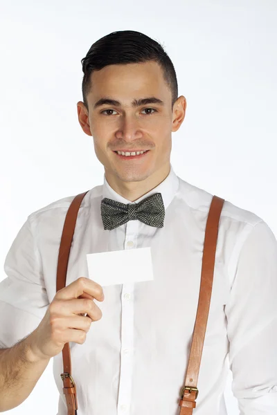 Young smiling man holding white card — Stock Photo, Image
