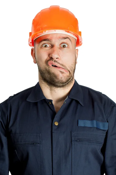 Witziger Arbeiter mit Helm und Rührung im Gesicht — Stockfoto