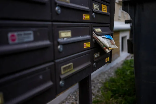 newspapers in the mailbox on the street